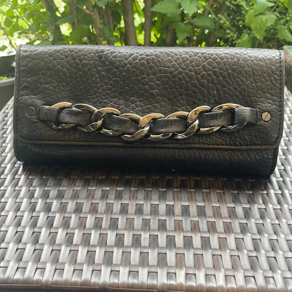 Michael kors Pebbled leather MK clutch with gun metal zipper.